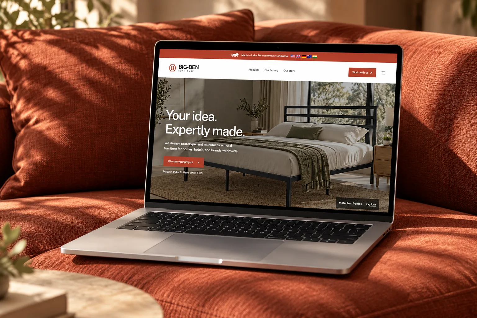 Big Ben Furniture website redesign displayed on a laptop on a terracotta sofa