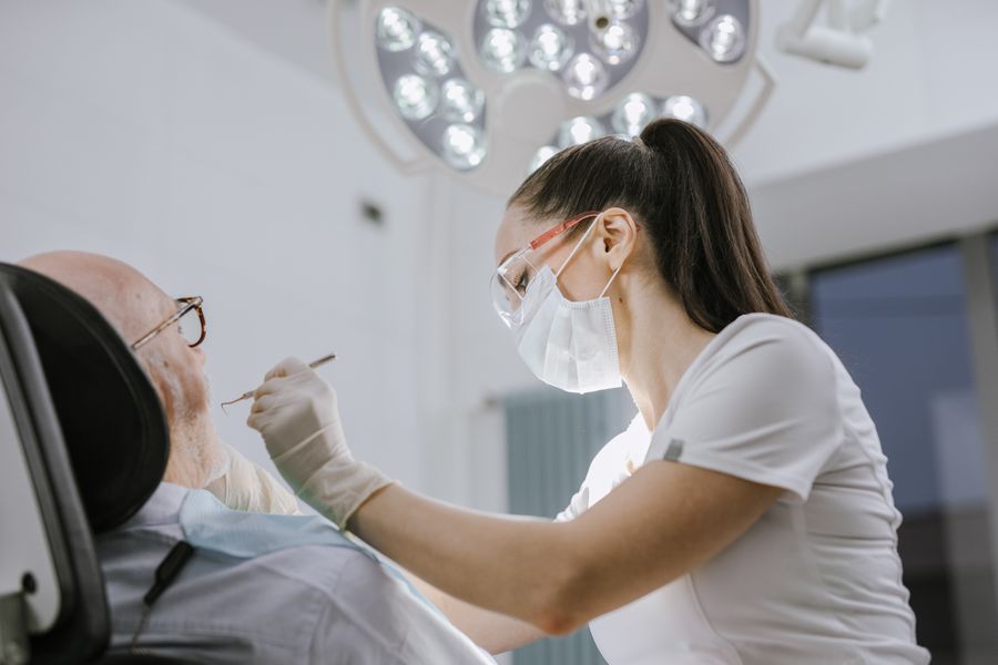 A dentist treating a patient in a bright modern dental practice