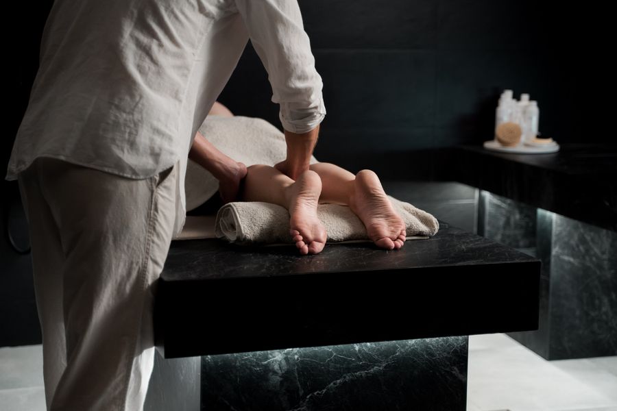 A therapist giving a treatment in a calm modern spa room