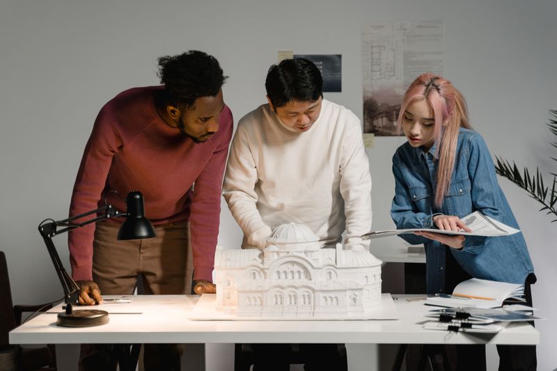 A team reviewing an architectural model in an office